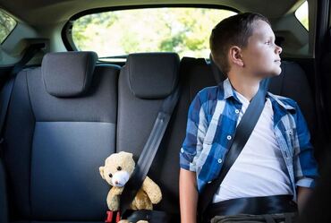 When can a child sit in the front seat in Texas